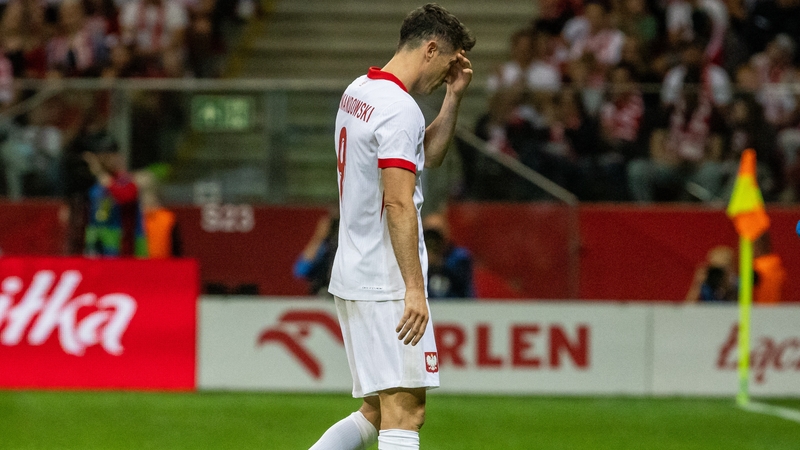Robert Lewandowski heads for the bench at the National Stadium in Warsaw