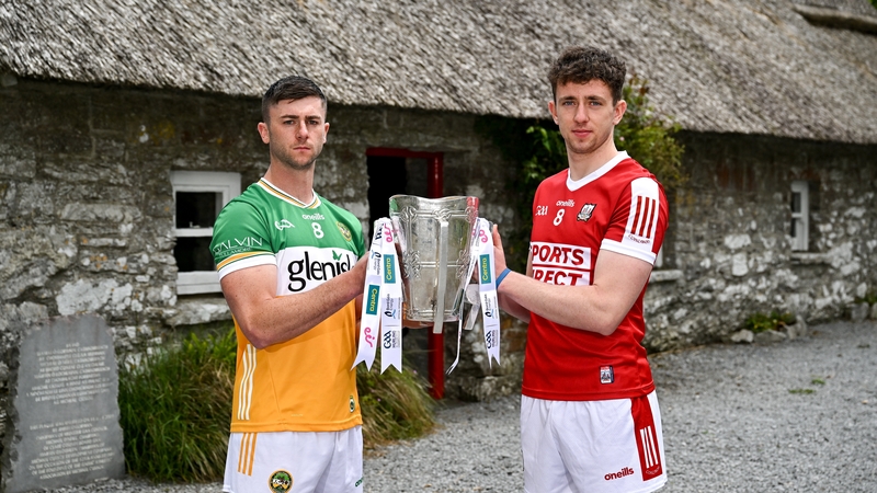 Offaly's Jason Sampson (L) and Cork's Ethan Twomey with the Liam MacCarthy Cup at the Michael Cusack Centre in Carran, Clare
