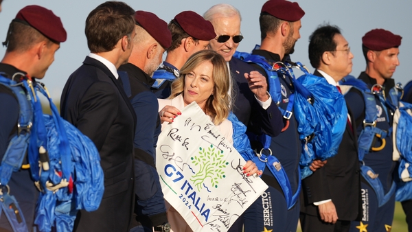 French President Emmanuel Macron, Italian Prime Minister Giorgia Meloni and US President Joe Biden watch a parachute drop at San Domenico Golf Club in Fasano, Italy