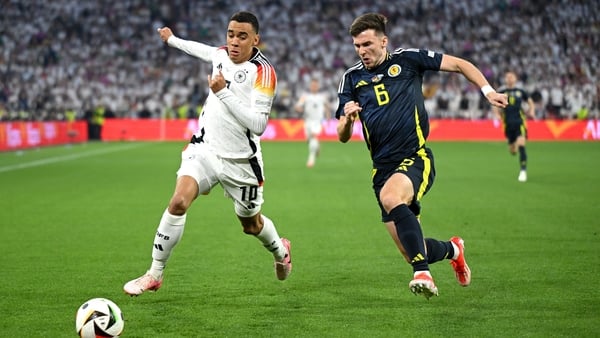 Jamal Musiala of Germany and Callum McGregor of Scotland