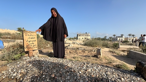 Palestinians visit the graves of their loved ones on Eid al-Adha in Deir al Balah, Gaza