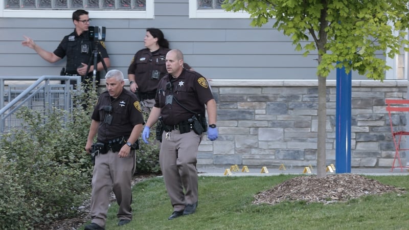 Oakland County Sheriff Evidence Technicians document the scene where a shooting took place at Brooklands Plaza Splash Pad