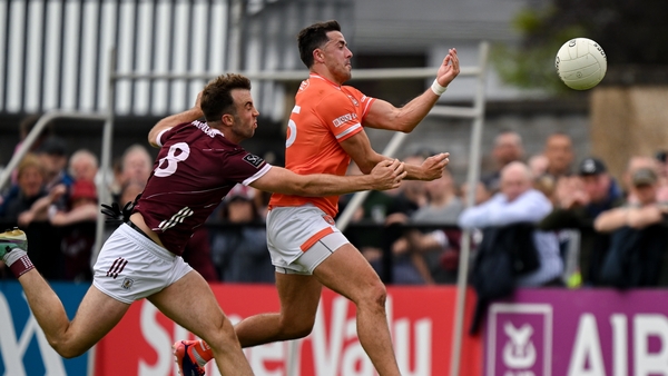 Stefan Campbell equalises for Armagh despite the attention of Paul Conroy