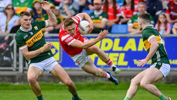 Ryan Burns of Louth takes flight as he attempts to evade two Kerry tacklers