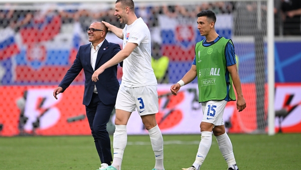 Francesco Calzona (L) celebrates with Denis Vavro (C) after Slovakia beat Belgium