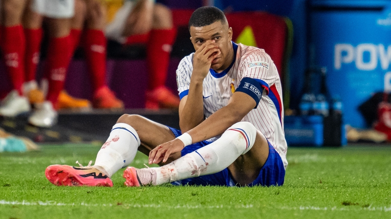 A bloodied Kylian Mbappe holds his nose at Merkur Spiel-Arena