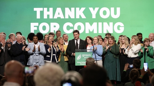 Eamon Ryan on stage surrounded by by party members earlier this year at the Green Party conference