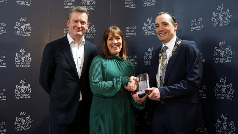 RTÉ's Evelyn O'Rourke receiving her award from Law Society of Ireland Director General Mark Garrett and President of the Law Society Barry MacCarthy