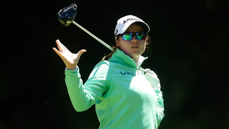 Maguire anxiously watches her tee shot on the seventh hole