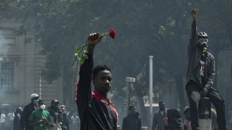 A demonstrator holds a rose during a nationwide strike to protest against tax hikes in Nairobi