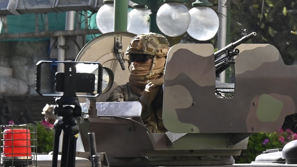 A soldier in an armoured vehicle is deployed outside Quemado Palace in La Paz