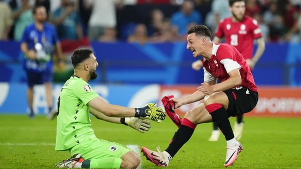 Georgia goalkeeper Giorgi Mamardashvili and team-mate Giorgi Gocholeishvili celebrate at the full-time whistle