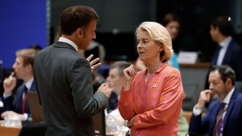 Ursula von der Leyen speaking to French President Emmanuel Macron at the summit in Brussels