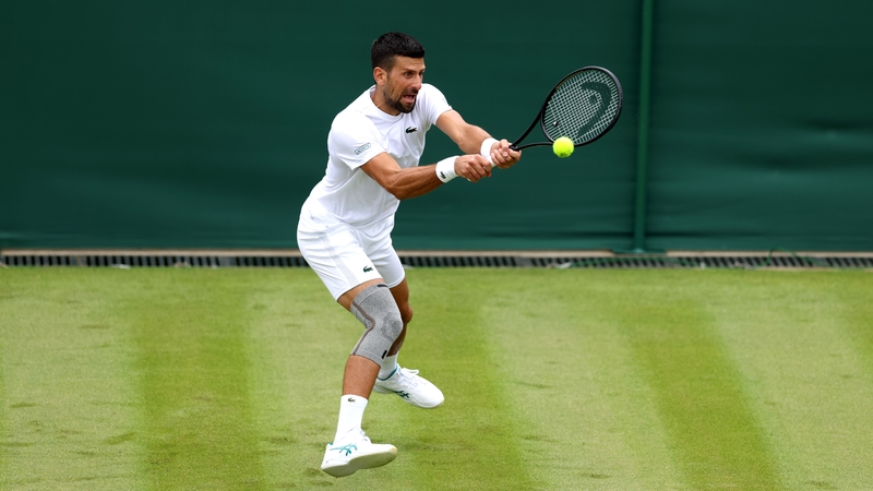 Novak Djokovic, complete with knee strapping, practising at Wimbledon
