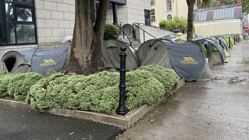 Tents pitched at the entrance of an empty office building on Charlemont Place
