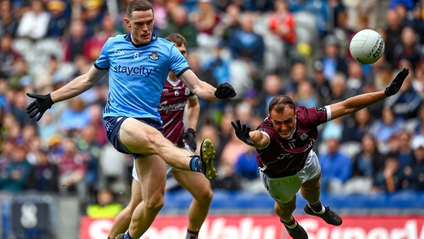 Brian Fenton kicks a point for Dublin despite the diving block of John Maher