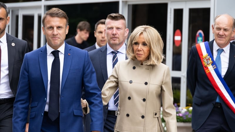 President Emmanuel Macron and his wife Brigitte Macron leave a polling station after voting in the French election first round