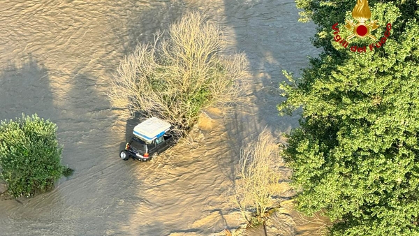 A family had to be rescued from a car stuck in a flooded river in the Piedmont region of Italy (Image: Italian Fire Service)