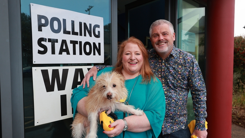 Alliance leader Naomi Long, her husband Michael and their dog Daisy, leave after casting their votes in the 2024 General Election at St Colmcille's Church in east Belfast