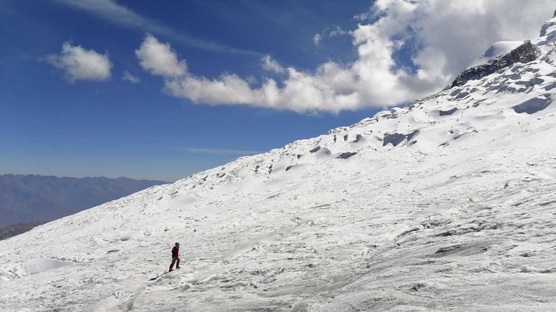 A member of the search team involved is seen climbing the snowy mountain of Huascarán (Image: Peruvian National Police)