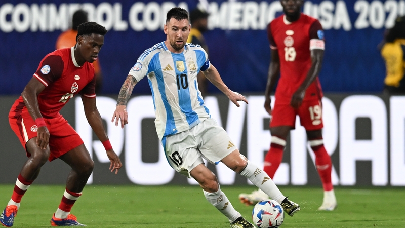 Lionel Messi of Argentina dribbles past Canada's Jonathan David