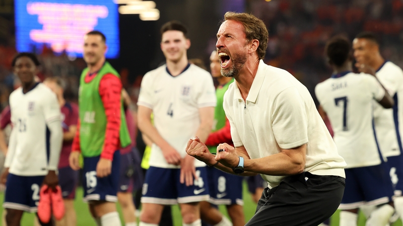 An animated Gareth Southgate celebrates in front of his players
