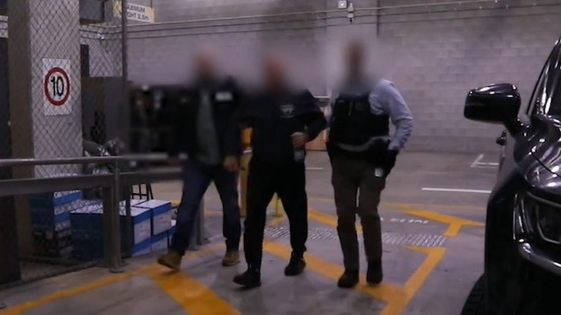 Igor Korolev (C) and his wife Kira have been living in Australia for more than ten years (Pic: Australian Federal Police)