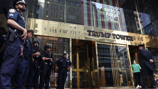 Police officers guard the front of Trump Tower in Manhattan a day after the shooting in Pennsylvania
