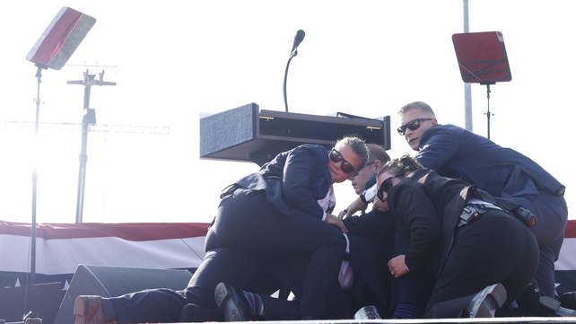 After Donald Trump fell to the floor of the stage, Secret Service agents rushed to cover him with their bodies