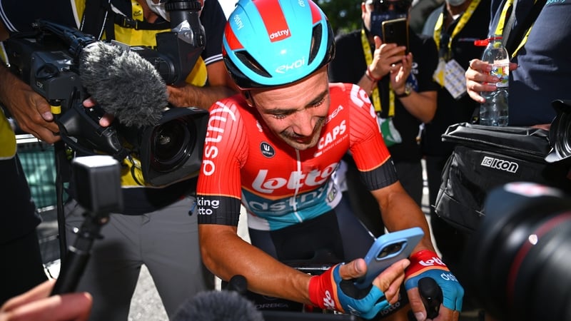 Stage winner Victor Campenaerts speaks to her girlfriend Nel immediately after his emotional victory