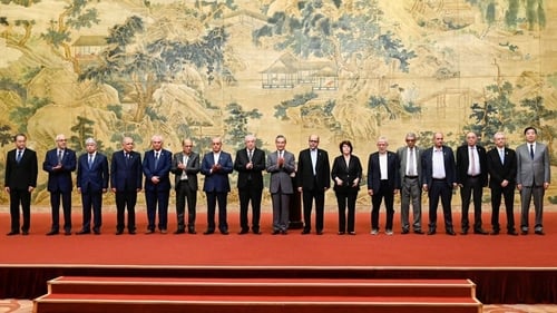China's Foreign Minister Wang Yi, centre, with members of the Palestinian factions during the signing of the 'Beijing declaration'