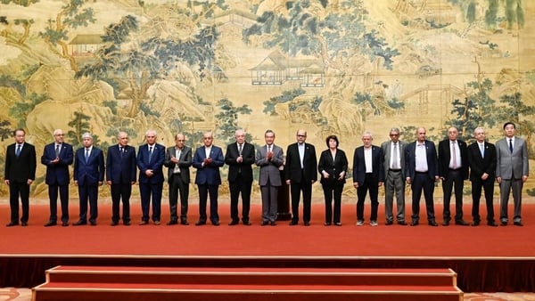 China's Foreign Minister Wang Yi, centre, with members of the Palestinian factions during the signing of the 'Beijing declaration'