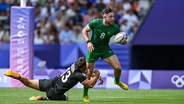 Joe Webber of New Zealand gets to grips with Ireland's Hugo Keenan