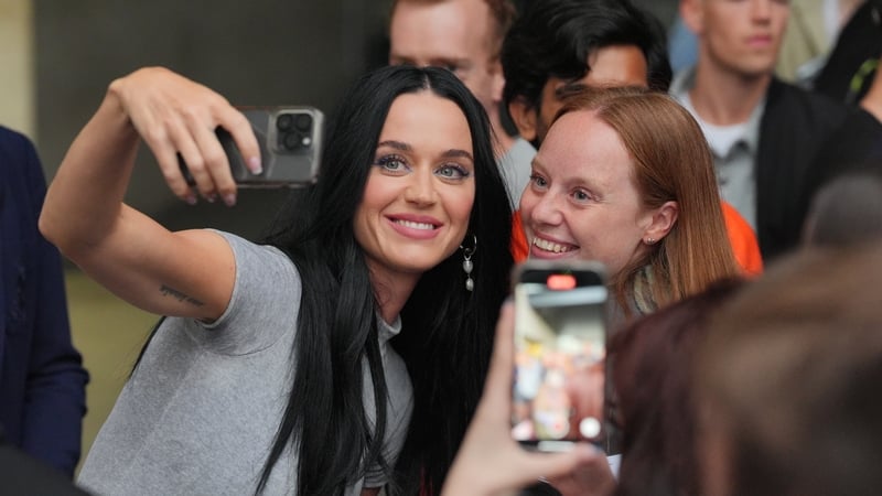 Katy Perry takes a selfie with a fan as she leaves The One Show studio at BBC Broadcasting House in London. PA Photo. Photo credit should read: Jonathan Brady/PA Wire
