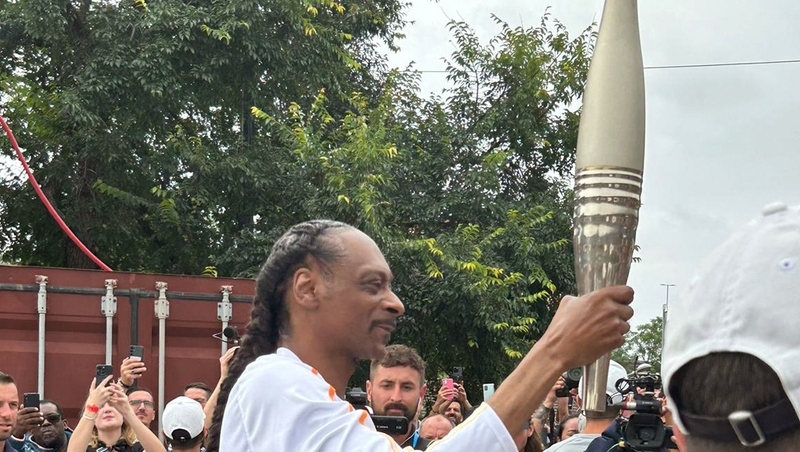 Snoop Dogg taking part in the final leg of the Olympic relay during the Opening Ceremony of the Paris 2024 Olympic Games along the River Seine on Friday