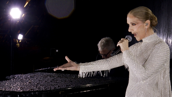 The Canadian singer belted out Edith Piaf's Hymne à l'amour from the middle of the Eiffel Tower on Friday, amid her battle with stiff person syndrome (SPS)