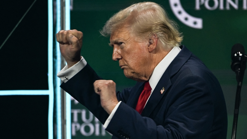 Donald Trump gestures after speaking at Turning Point Action's 'The Believers Summit' in West Palm Beach, Florida