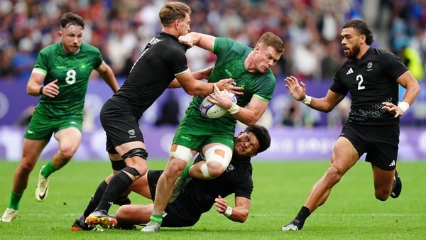 Zac Ward tries to break free of a pair of New Zealand defenders