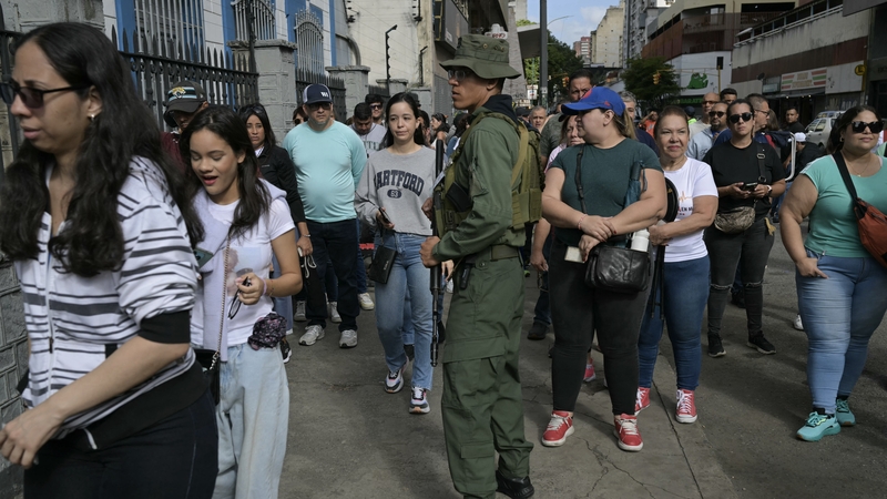 People queue outside a polling station in Caracas during the Venezuelan election