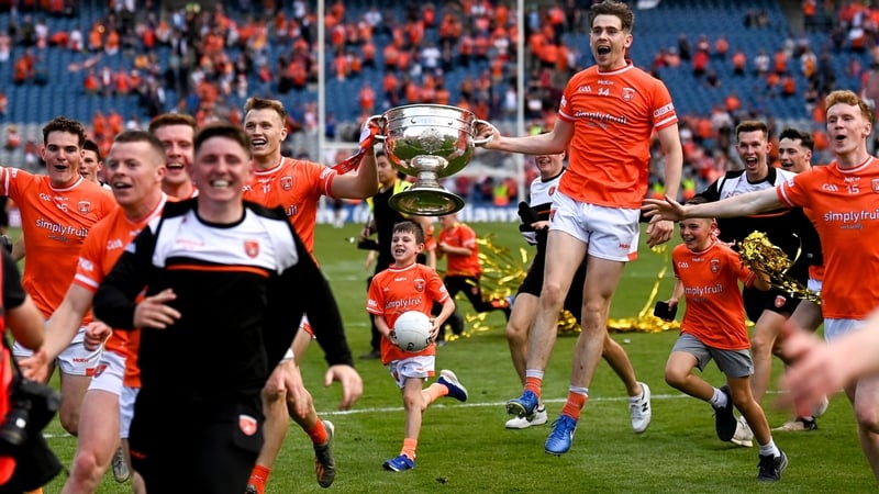 Rian O'Neill and Andrew Murnin carry the Sam Maguire Cup as Armagh celebrate their win
