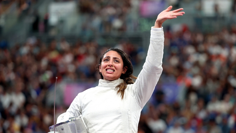 Nada Hafez of Team Egypt applauds fans after her victory in the sabre event against Elizabeth Tartakovsky of Team United States