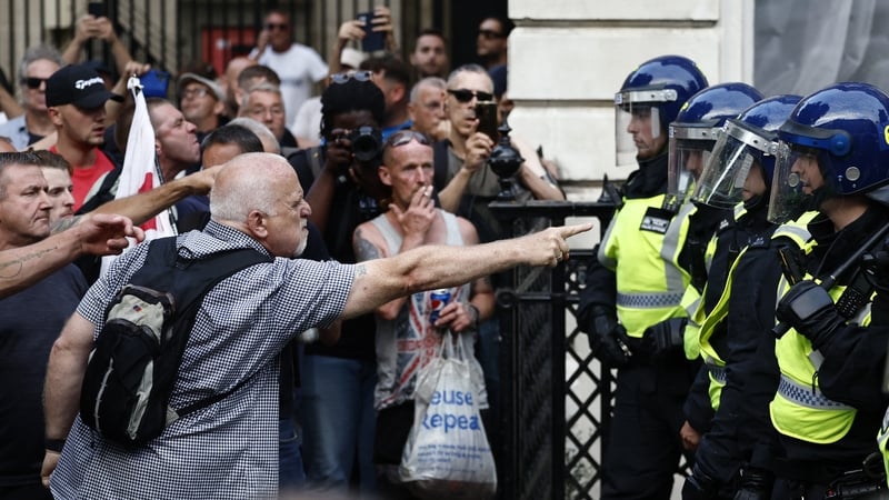 Protesters remonstrate with police officers outside the entrance to 10 Downing Street