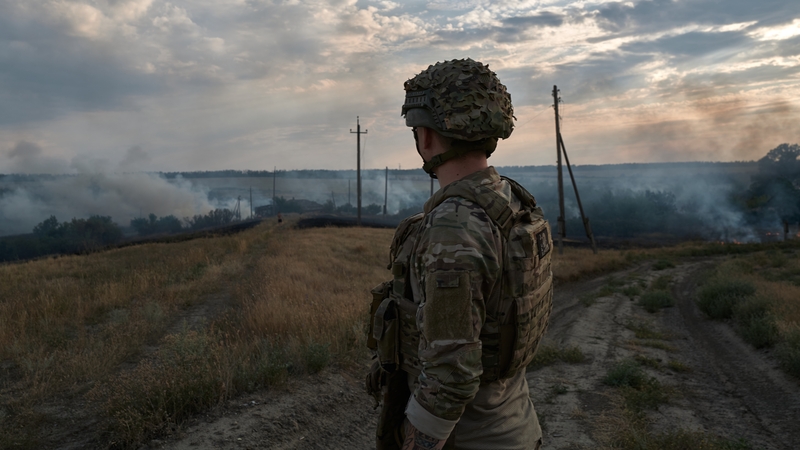 A soldier looking at a fire on the frontline in Donetsk, Ukraine, earlier this week