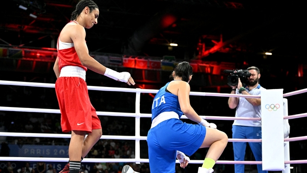 Algeria's Imane Khelif (in red) gestures to Italy's Angela Carini after their fight