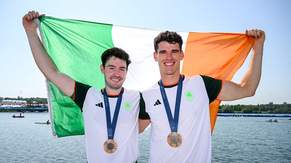 Philip Doyle, right, and Daire Lynch hold a tricolour aloft after making their own history