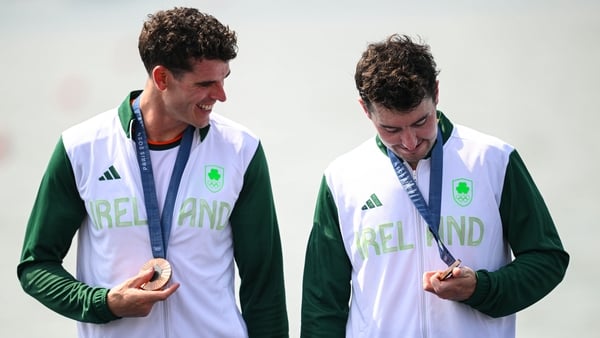 Philip Doyle (left) and Daire Lynch inspect their Olympic medals