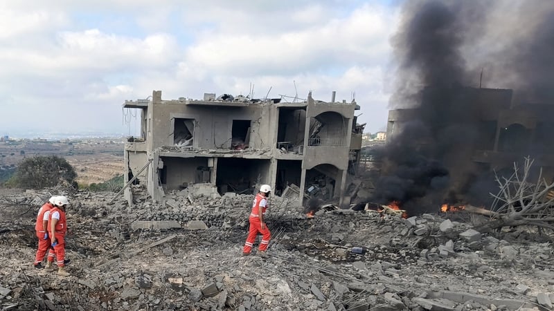 Members of Lebanese Red Cross inspect damage following an Israeli strike on the town of Shama in southern Lebanon