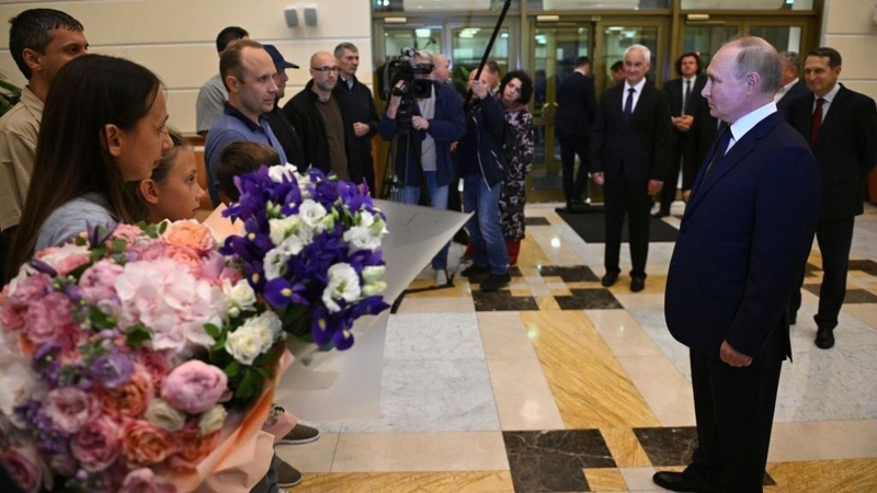 Russian President Vladimir Putin welcoming the prisoners released following the swap at an airport in Moscow (Pic: Kremlin Press Office)