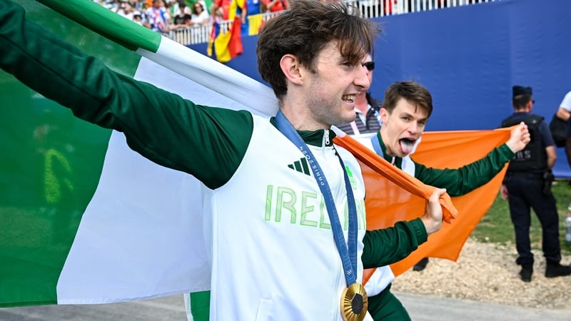 Paul O'Donovan (l) and Fintan McCarthy celebrate with their gold medals after winning the men's lightweight double sculls