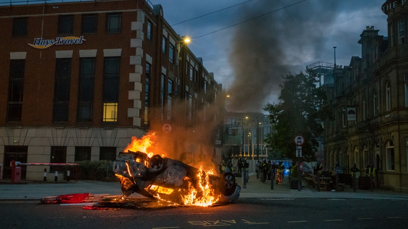 Demonstrators threw stones at police in riot gear before overturning vehicles, setting a car alight and starting a fire next to a police office